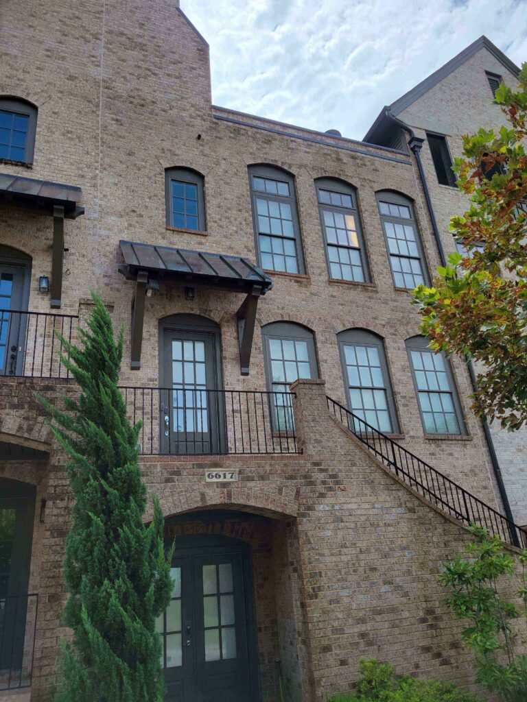 Brick home after algae was washed off the wall