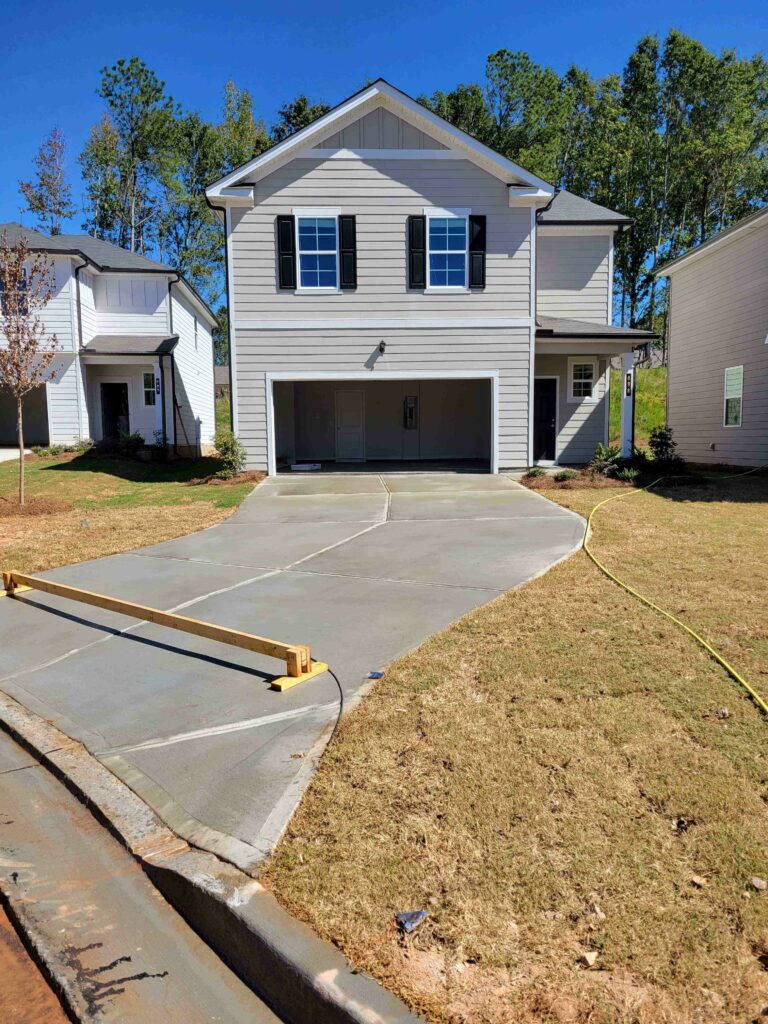 New-home concrete driveway after a pressure wash